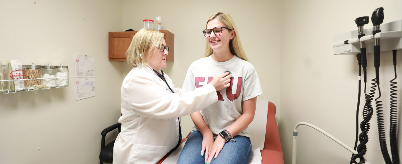 Primary care physician checks patient's heart rate
